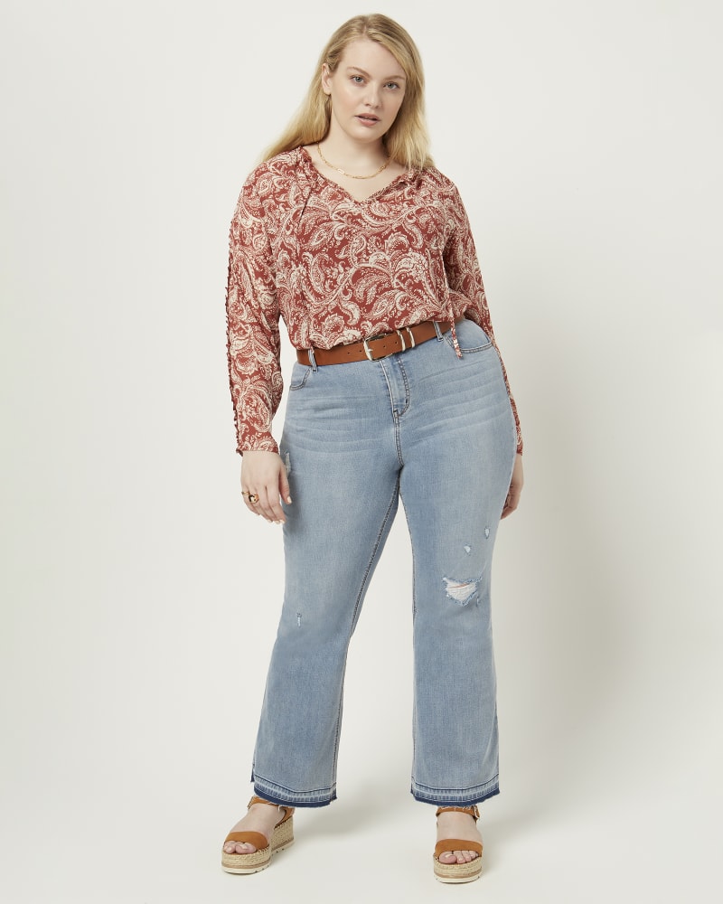 Front of a model wearing a size 16 Noor Release Hem Flare Jean in Light Wash by Meri Skye. | dia_product_style_image_id:210642